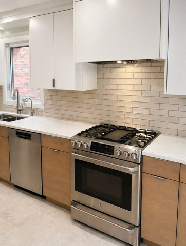 Remodeled kitchen with white upper cabinets, wood lower cabinets, tile backsplash, and stainless-steel range